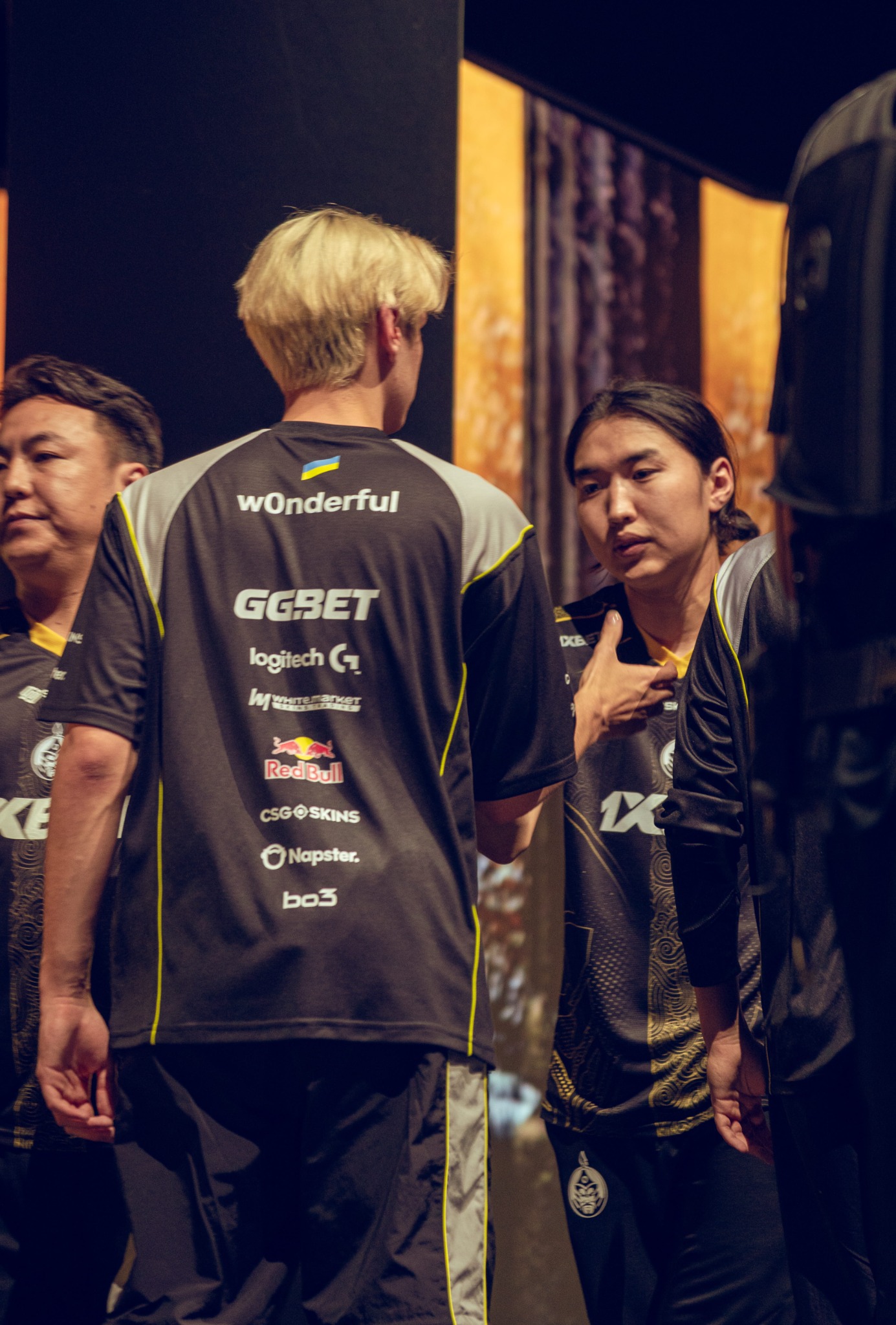 Players sharing a quiet moment beside the stage