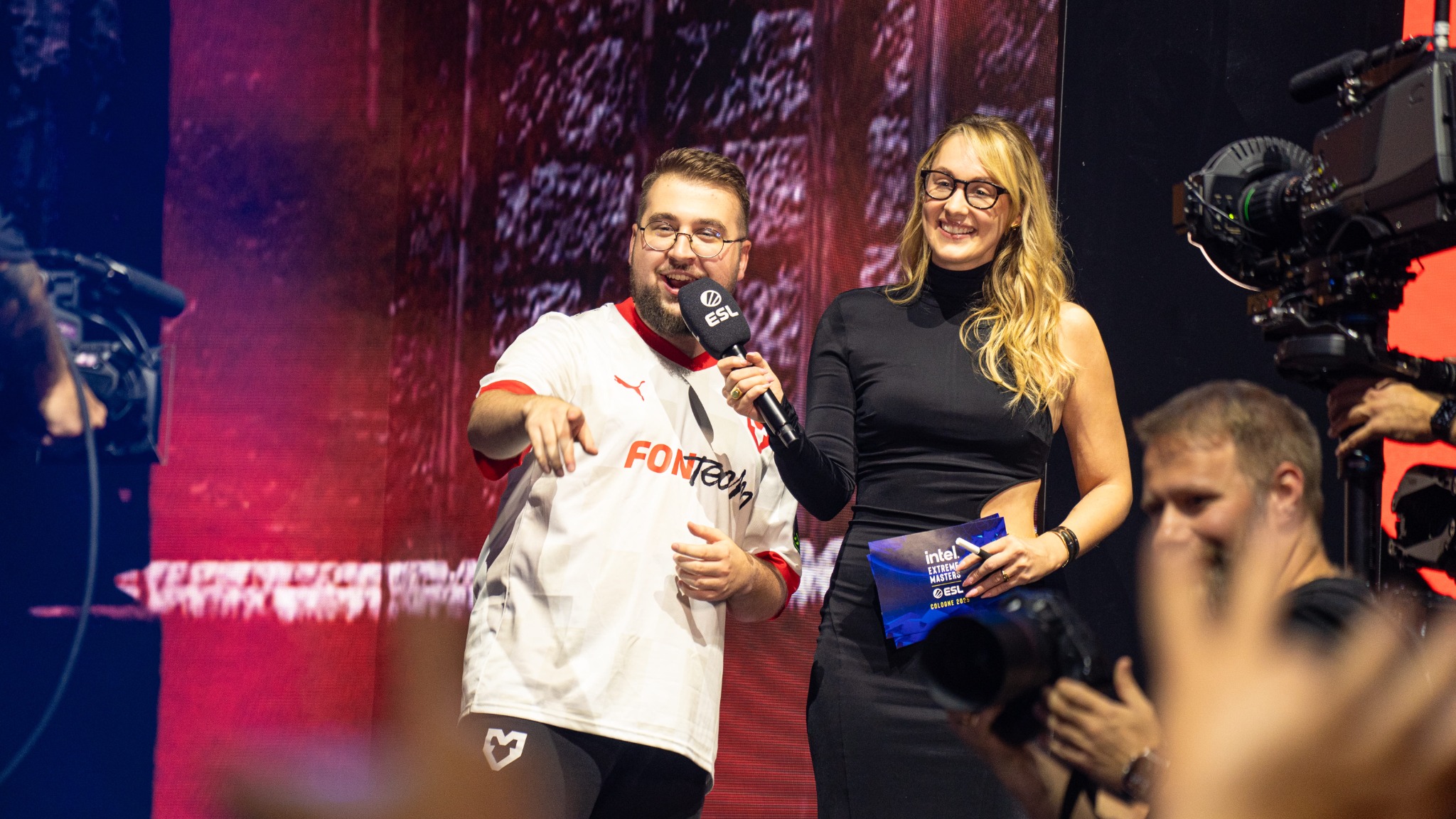 Live esports interview surrounded by broadcast cameras