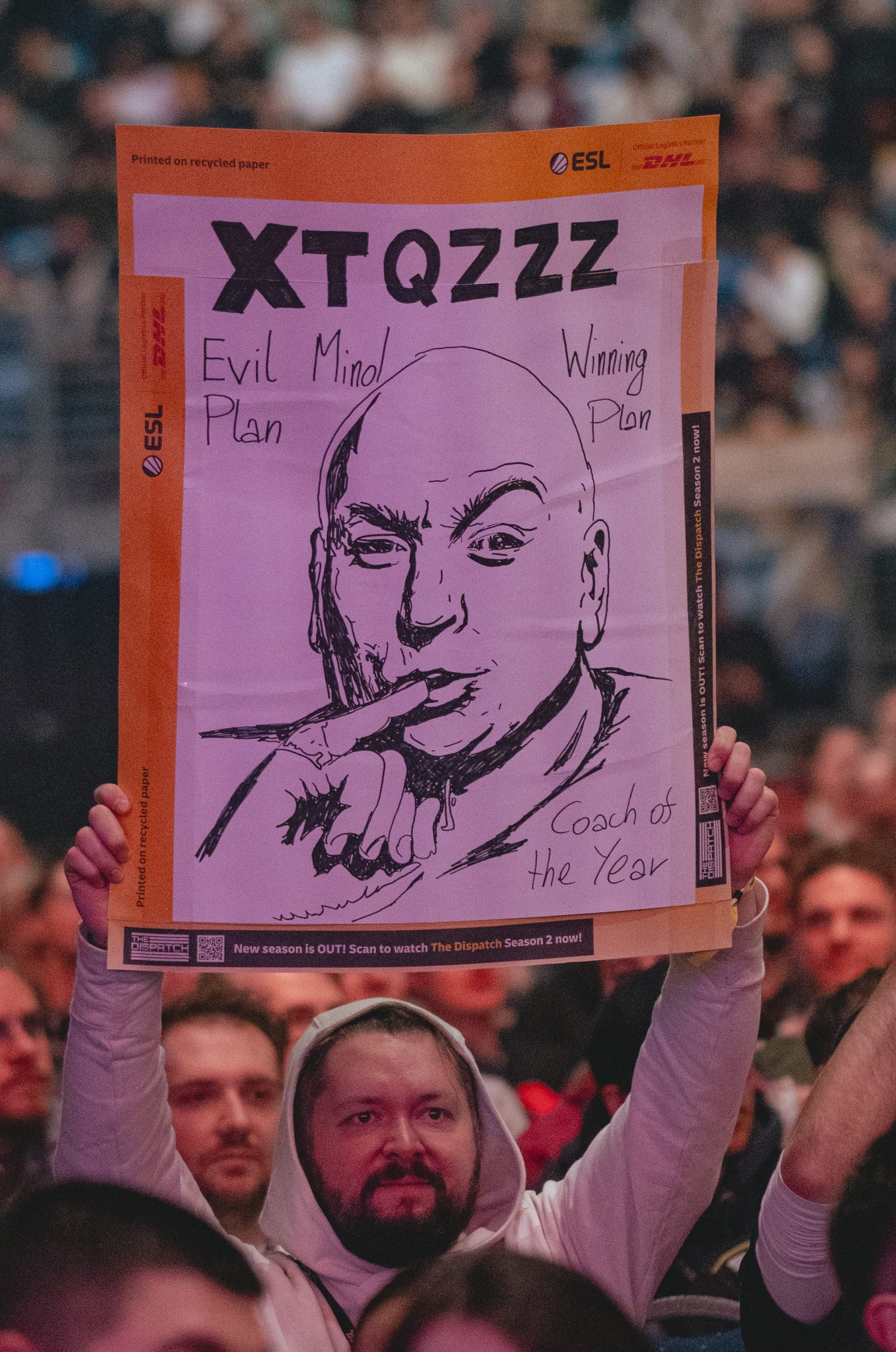 Fan holding a hand-drawn sign in the arena